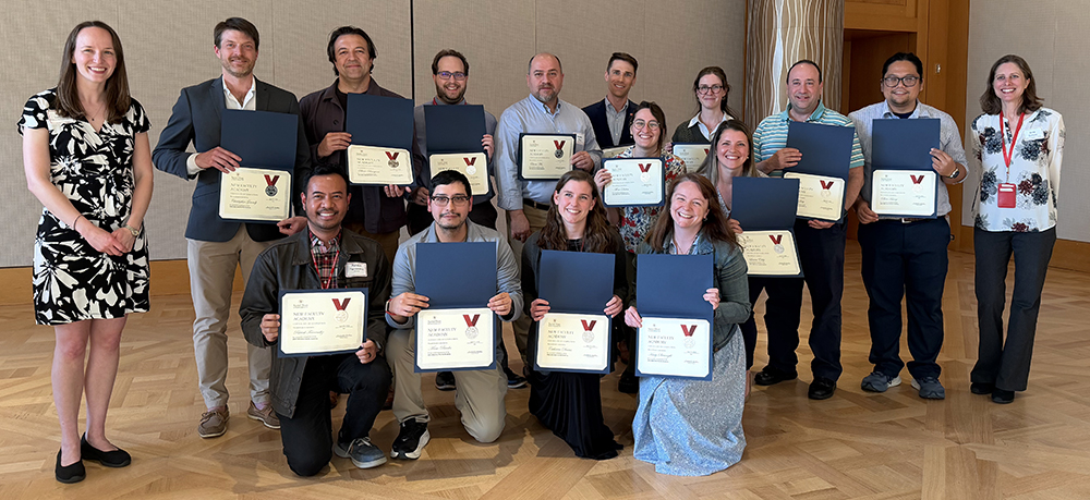 group photo of people holding completion certificates