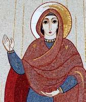 The Virgin Mary stands with yarn in her hand