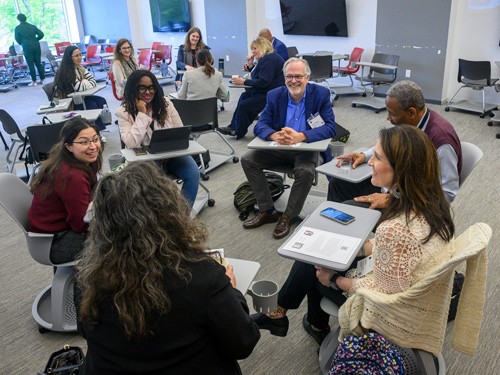 Group of professionals sitting in a circle talking