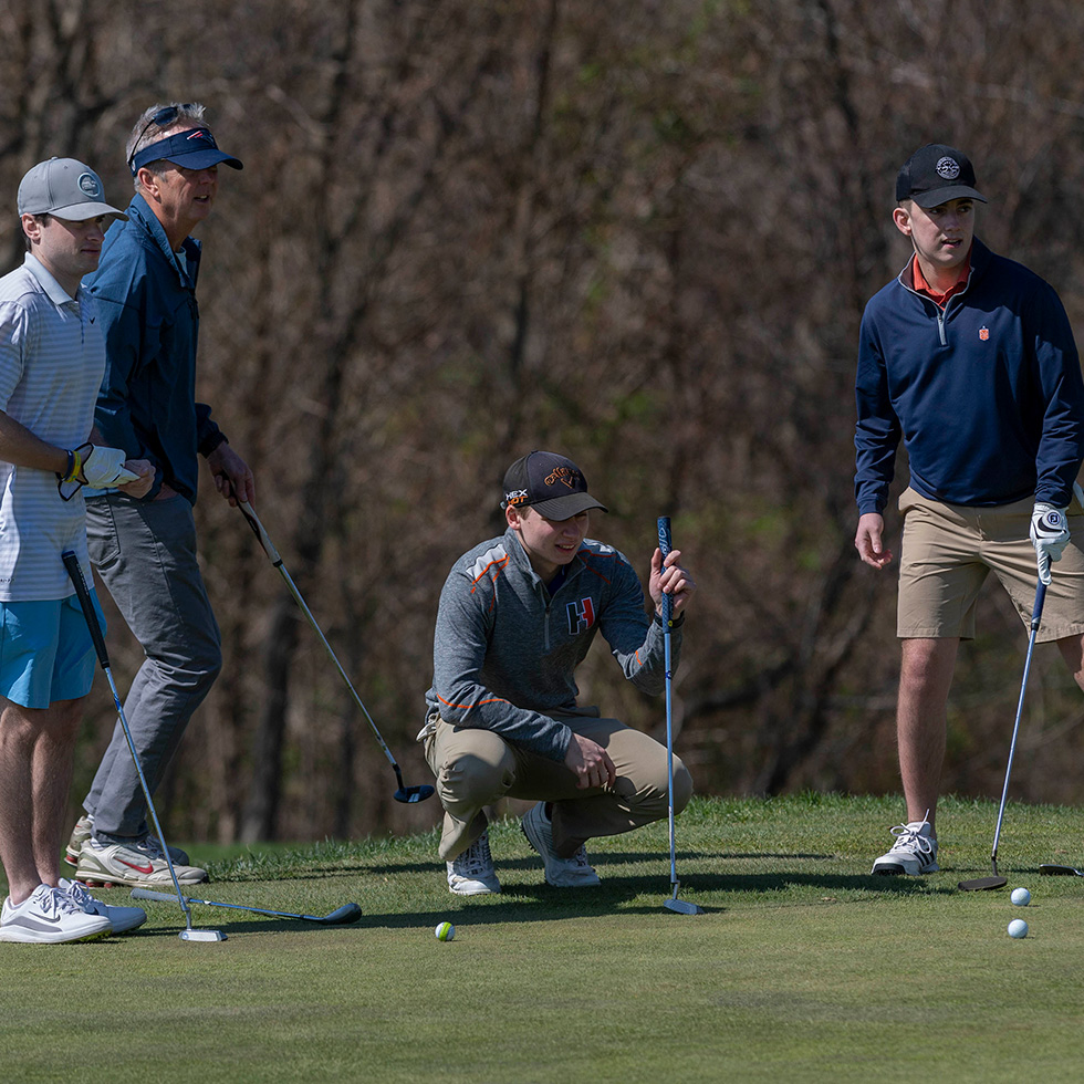 A golfer evaluates his putt at the Welch Cup Classic golf tournament.