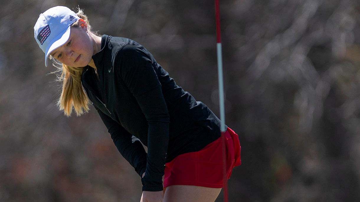 A WCBT sinks her putt during the annual golf tournament.