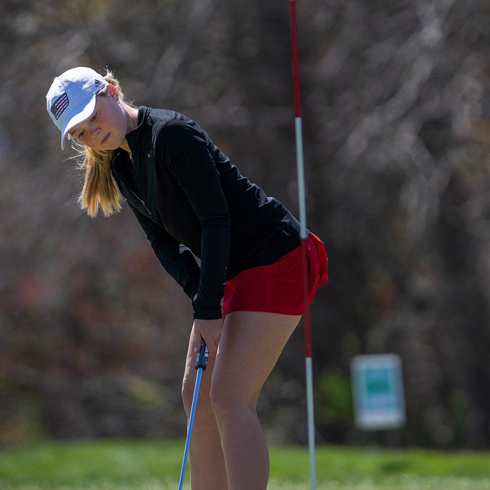 A WCBT sinks her putt during the annual golf tournament.