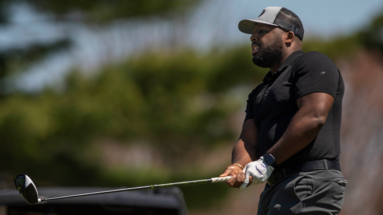 A golfer tracks his drive during the Welch Cup golf tournament.