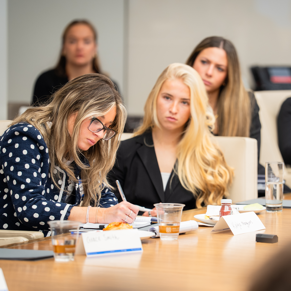 Students listening and taking notes during corporate visit