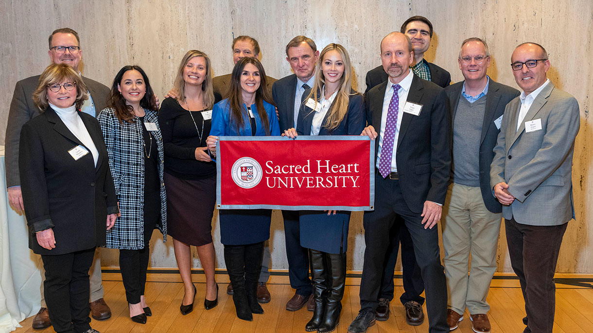 DBA alumni connect at a reception.