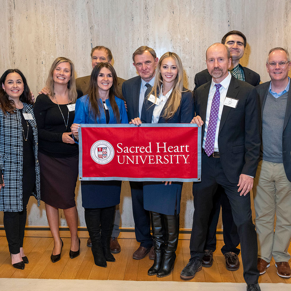 DBA alumni connect at a reception.