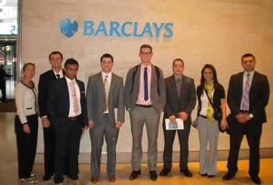 students standing in front of Barclay sign