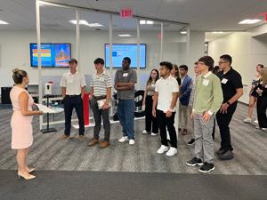 Group of students listening to woman talk