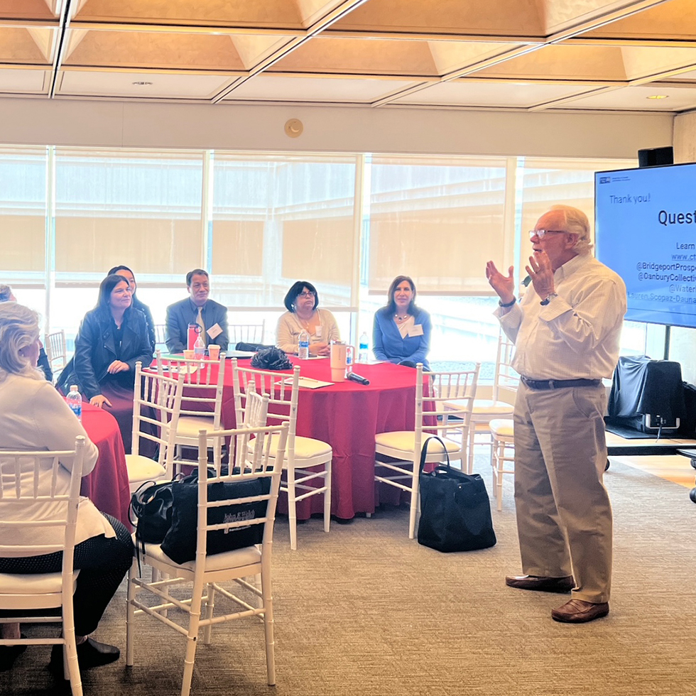 Bill Hass addresses a crowd at a conference