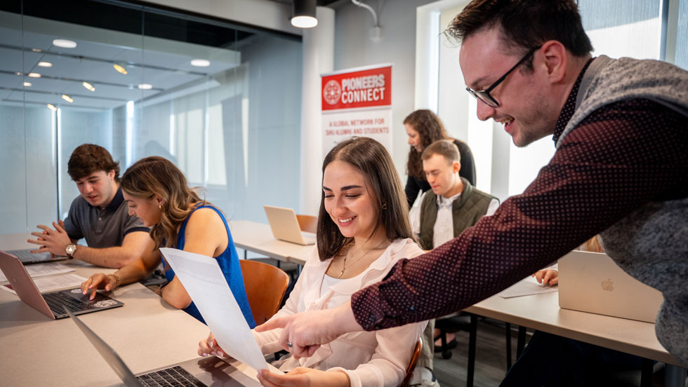 Professor looking over a paper with a student