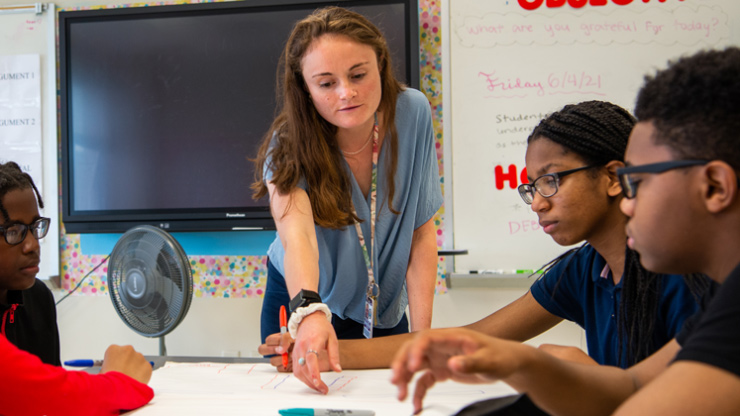 Teacher working with students in classroom