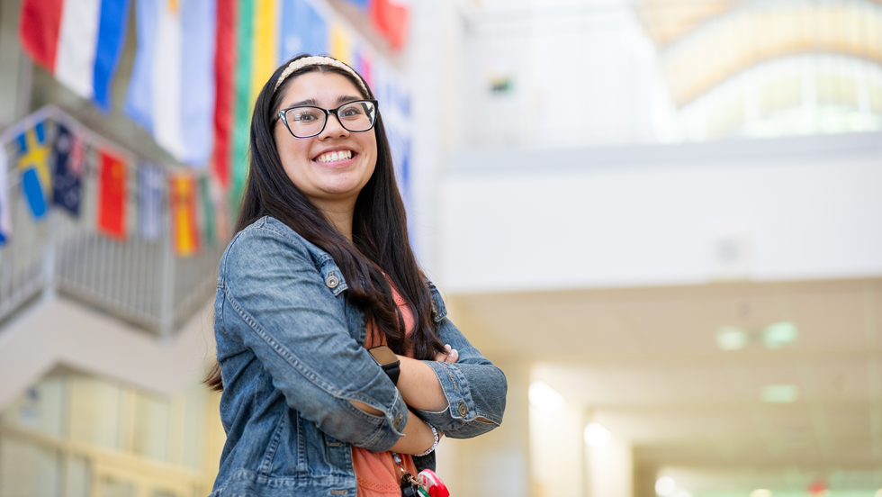 Teacher smiling in a school hallway