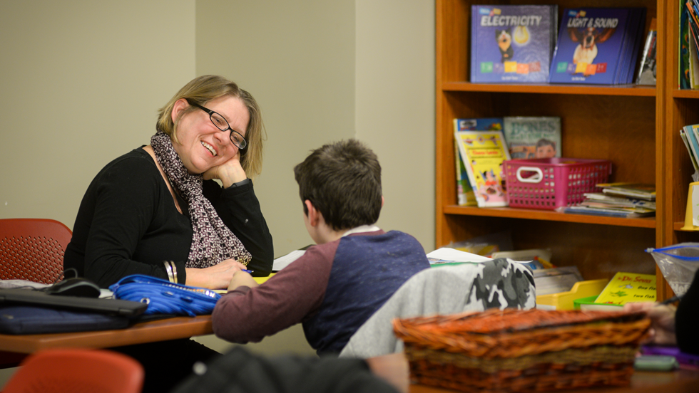 Teacher working with young student