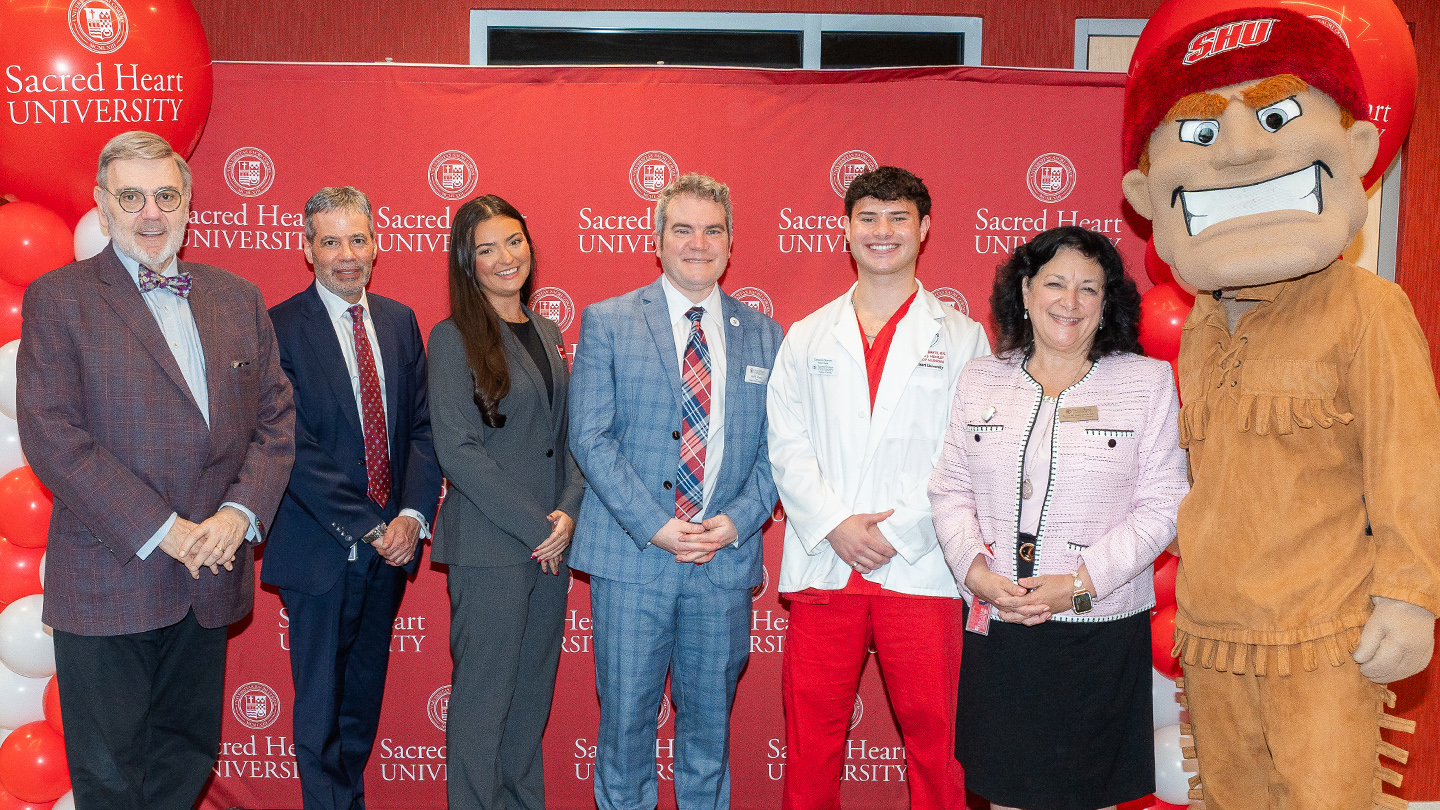 group photo of Sacred Heart University officials and students at a ribbon-cutting ceremony at the Center for Healthcare Education