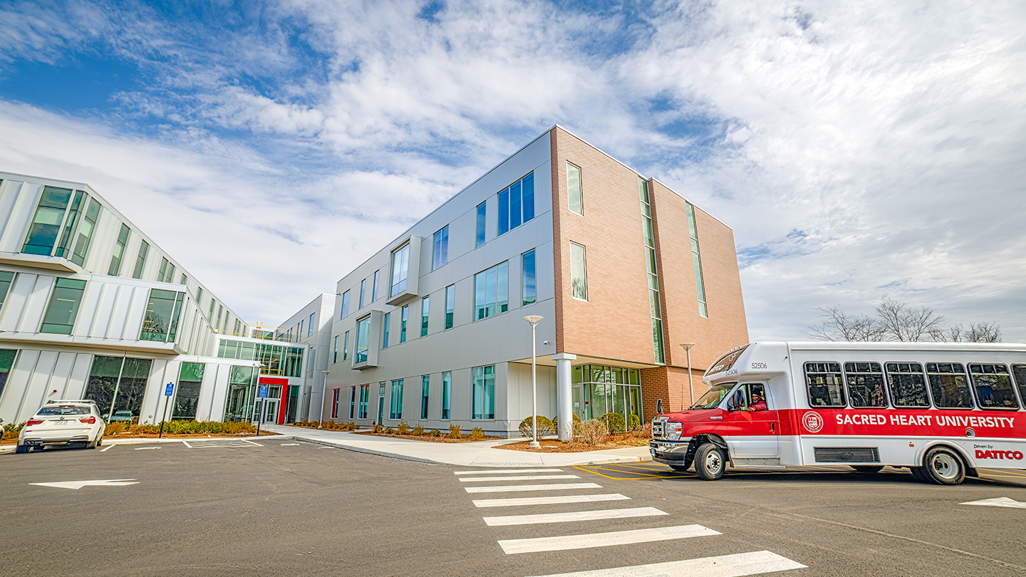 building with a shuttle bus in front of it