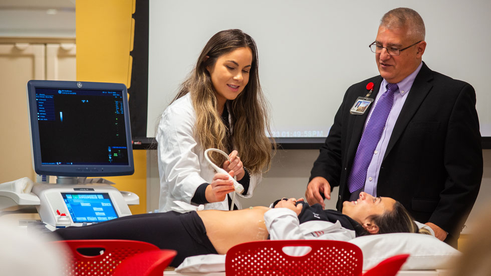 Student and professor performing an ultrasound