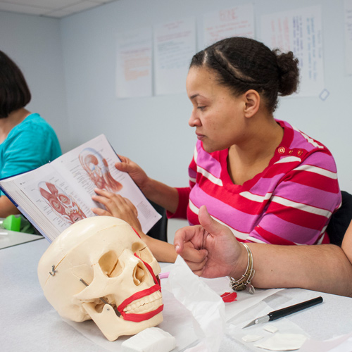 SLP student looking at book