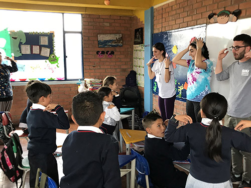 3 teachers leading a class
