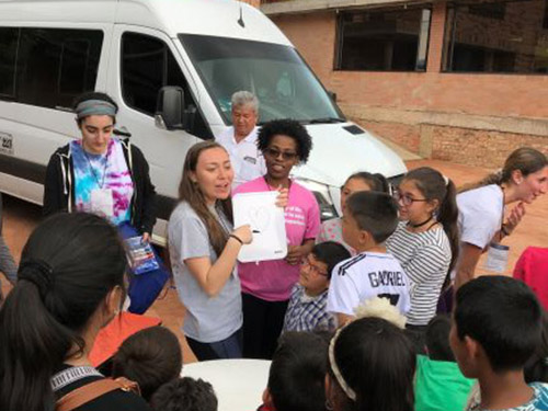 Woman teaching English to a group of students