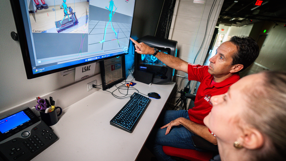 Professor and student looking at computer screen