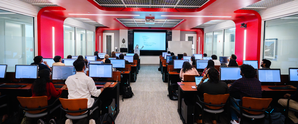 Students listening to professor at computers in AI Lab
