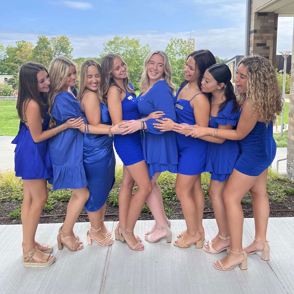 Chi Omega members dressed in blue dresses for recruitment