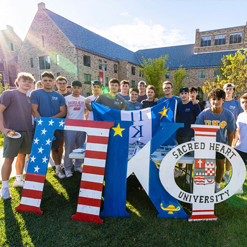 group photo of fraternity members with their letters