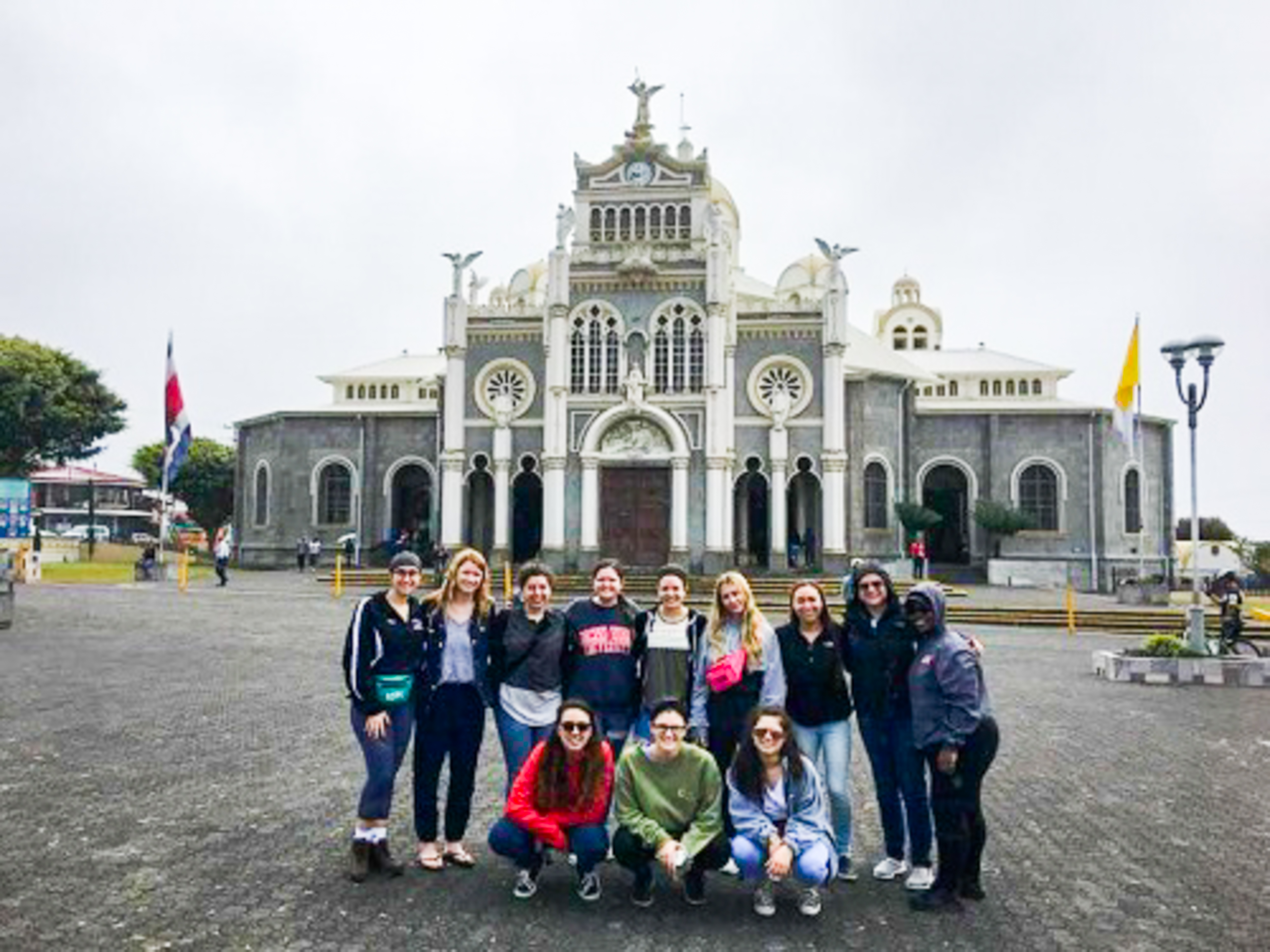 Group of students with building in back