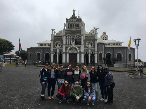 Group of students with building in back