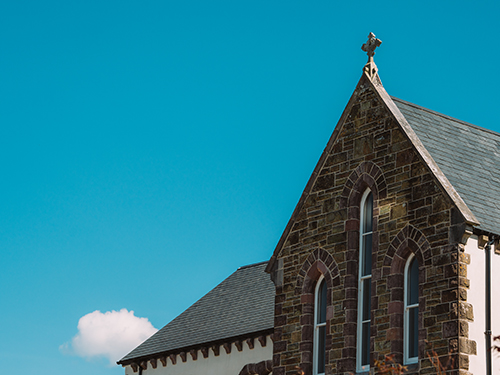 Christian cross on top of a stone building