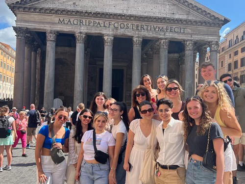 a group of college students in front of the Pantheon in Rome