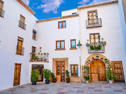 Javea Xabia spanish white Mediterranean facades with flower pots in Alicante of Spain