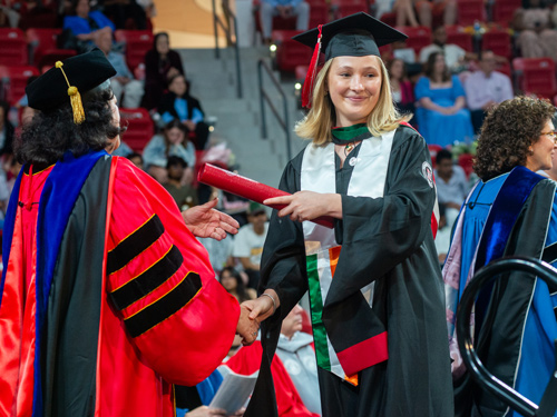 Graduate getting diploma at Commencement