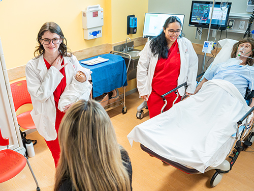 Two nursing students in a hospital simulation lab