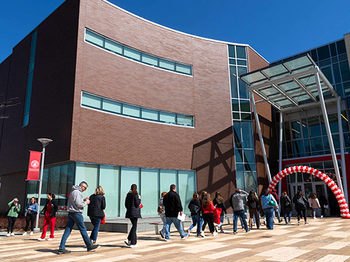 a line of people walking into a building