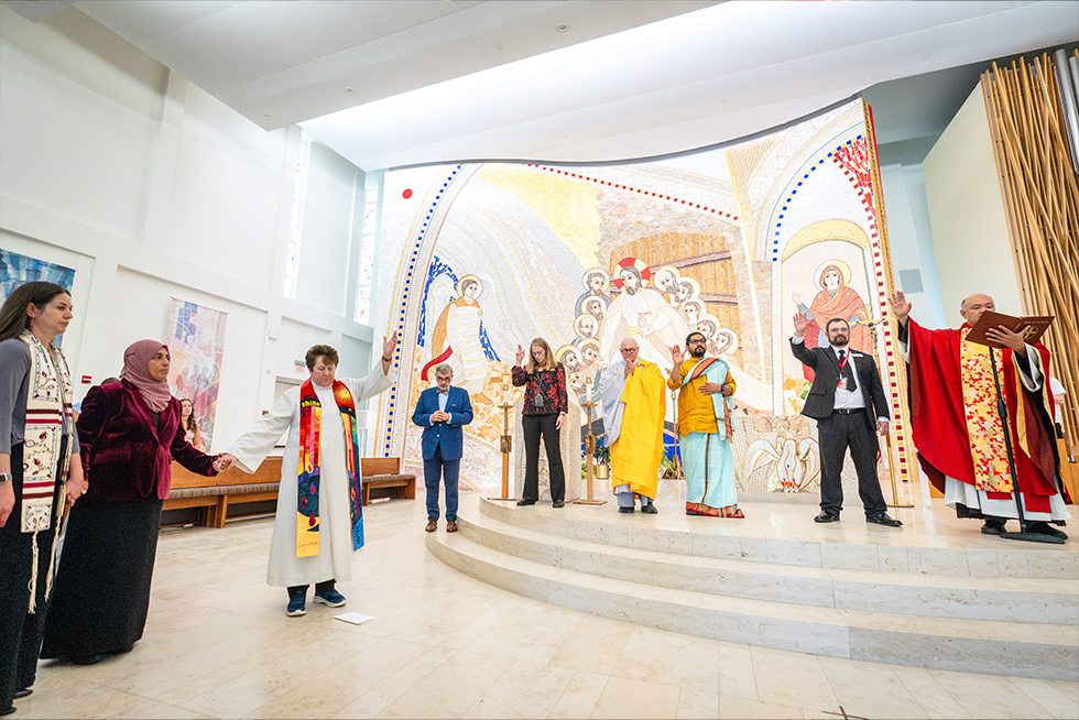 interfaith clergy do a blessing at a Sacred Heart University mass
