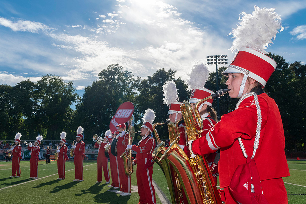 A marching band playing on a football field
