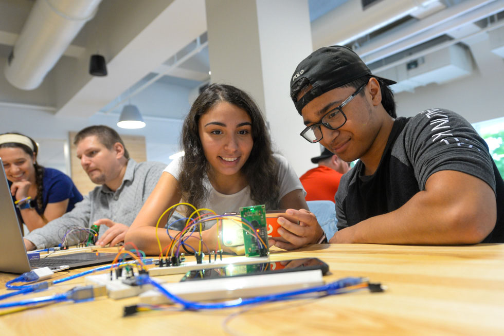 people working on an engineering project in a makerspace