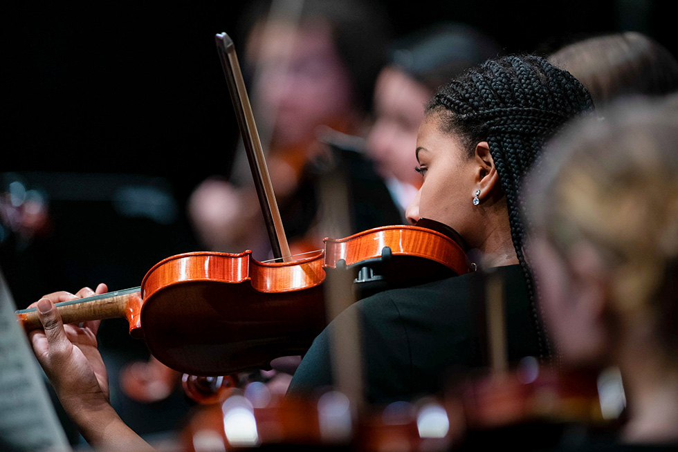 a person playing a violin during a concert
