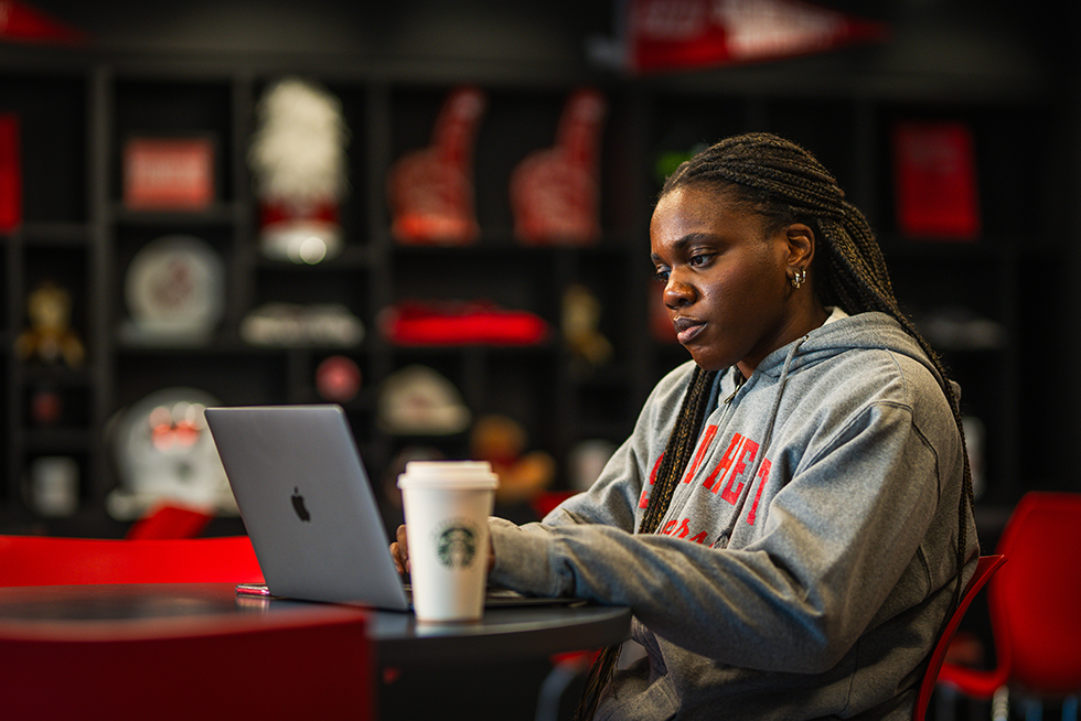 a person working on a laptop in a cafe