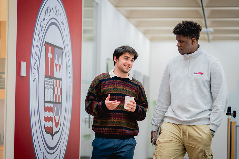 two graduate students chatting over coffee