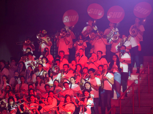a pep band playing in bleachers