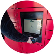 person holding a smartphone up to a kiosk