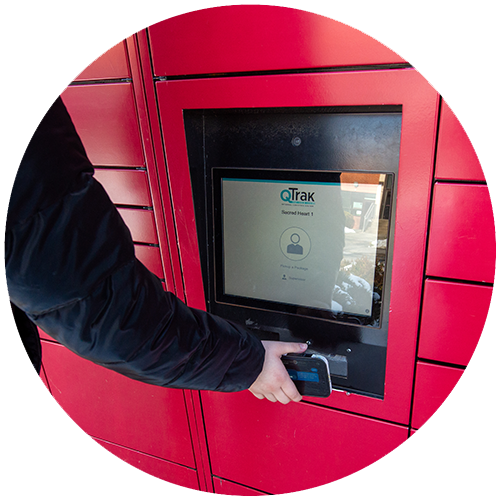 person holding a smartphone up to a kiosk