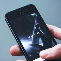 hand holding a phone with Uber app