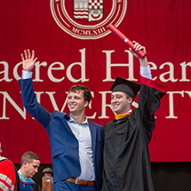A student celebrating with his brother at commencement