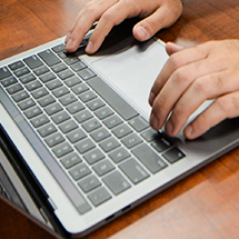 fingers on a laptop keyboard