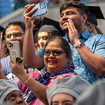 people smiling and taking photos with their phones