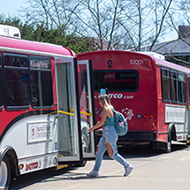 woman getting on a shuttle bus