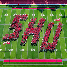 aerial photo of a football field with students forming the letters SHU
